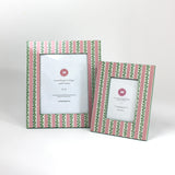 a set of two Hand painted picture frames featuring a pink and white striped motif
