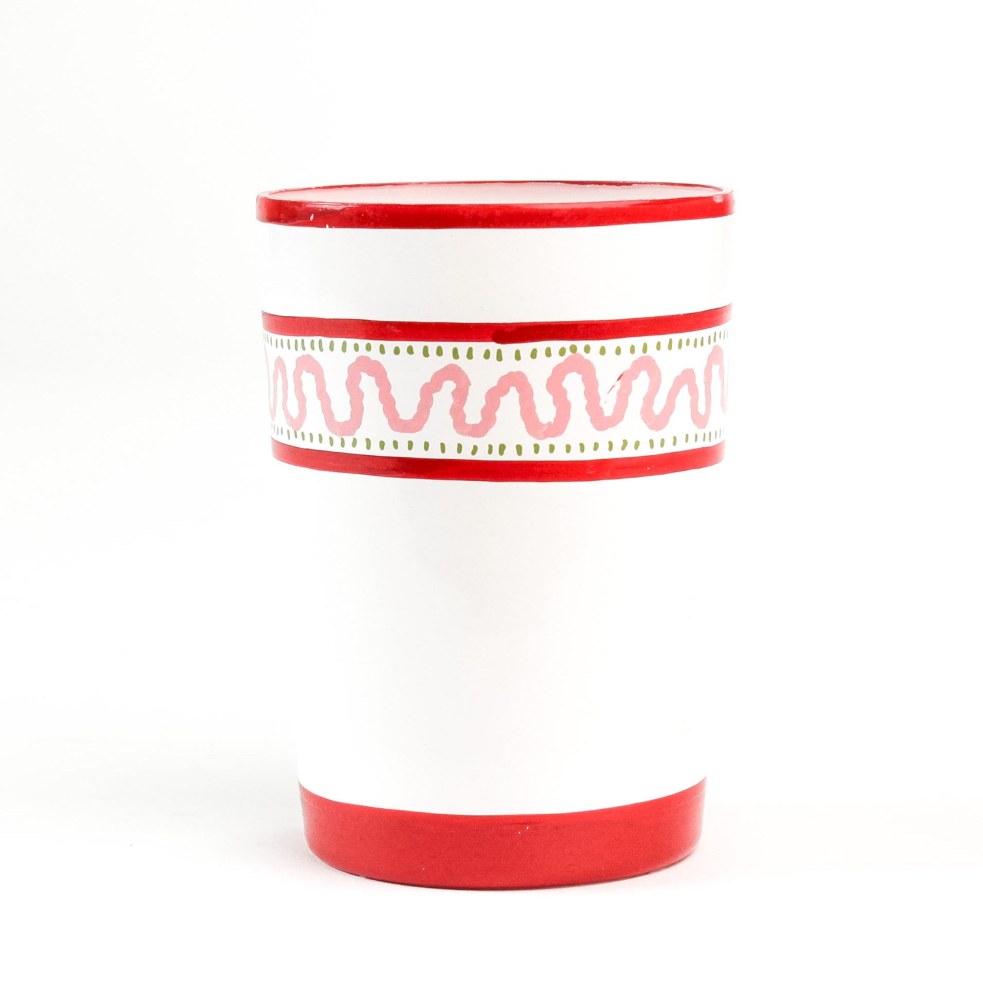 a hand-made white glasses with red stripe and pink pattern in a white background