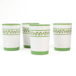 set of 4 hand-made white glasses with green stripe and wavy pattern in a white background