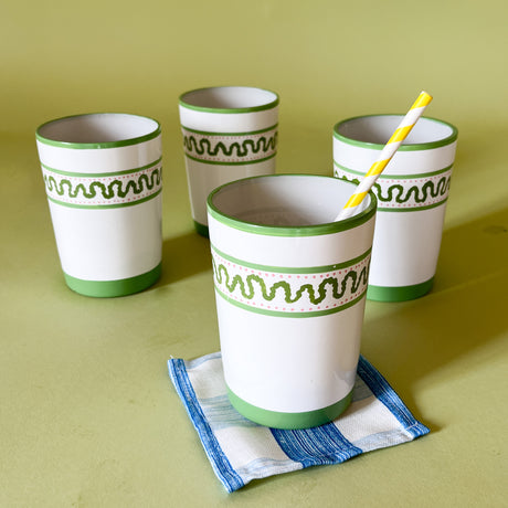 four hand-made white glasses with green stripe and wavy pattern