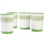 a set of 4 hand-made white glasses with green stripe and wavy pattern in a white background