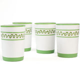 a set of 4 hand-made white glasses with green stripe and wavy pattern in a white background