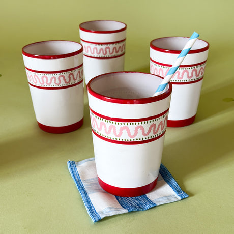 four hand-made white glasses with red stripe and pink pattern