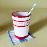 a hand-painted white glass with red stripe and pink wavy design