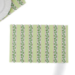 a green paper placemats featuring a striped pattern in a white background. 