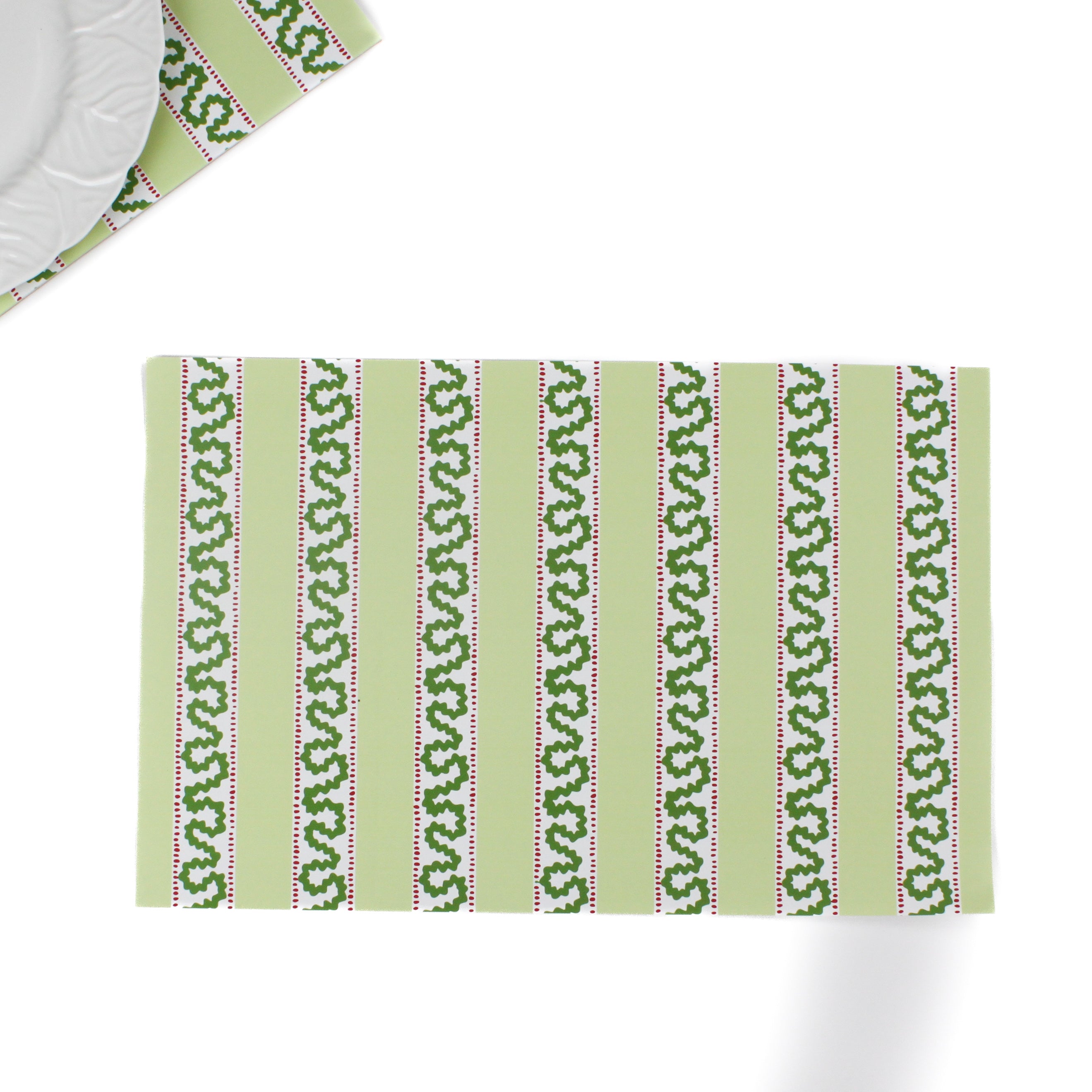 a green paper placemats featuring a striped pattern in a white background. 