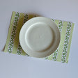 green paper placemats featuring a striped pattern from Madcap Cottage