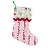Decorative striped red and pink Christmas stocking with a green cuff with pugs on it on a white background