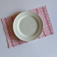 red and pink paper placemats featuring a striped pattern from Madcap Cottage