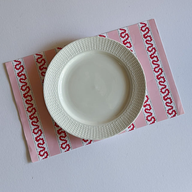 red and pink paper placemats featuring a striped pattern from Madcap Cottage