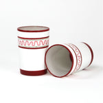 two red painted glasses with a squiggly motif at the top called "Harbor Trail" by madcap cottage
