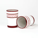 two red painted glasses with a squiggly motif at the top called "Harbor Trail" by madcap cottage