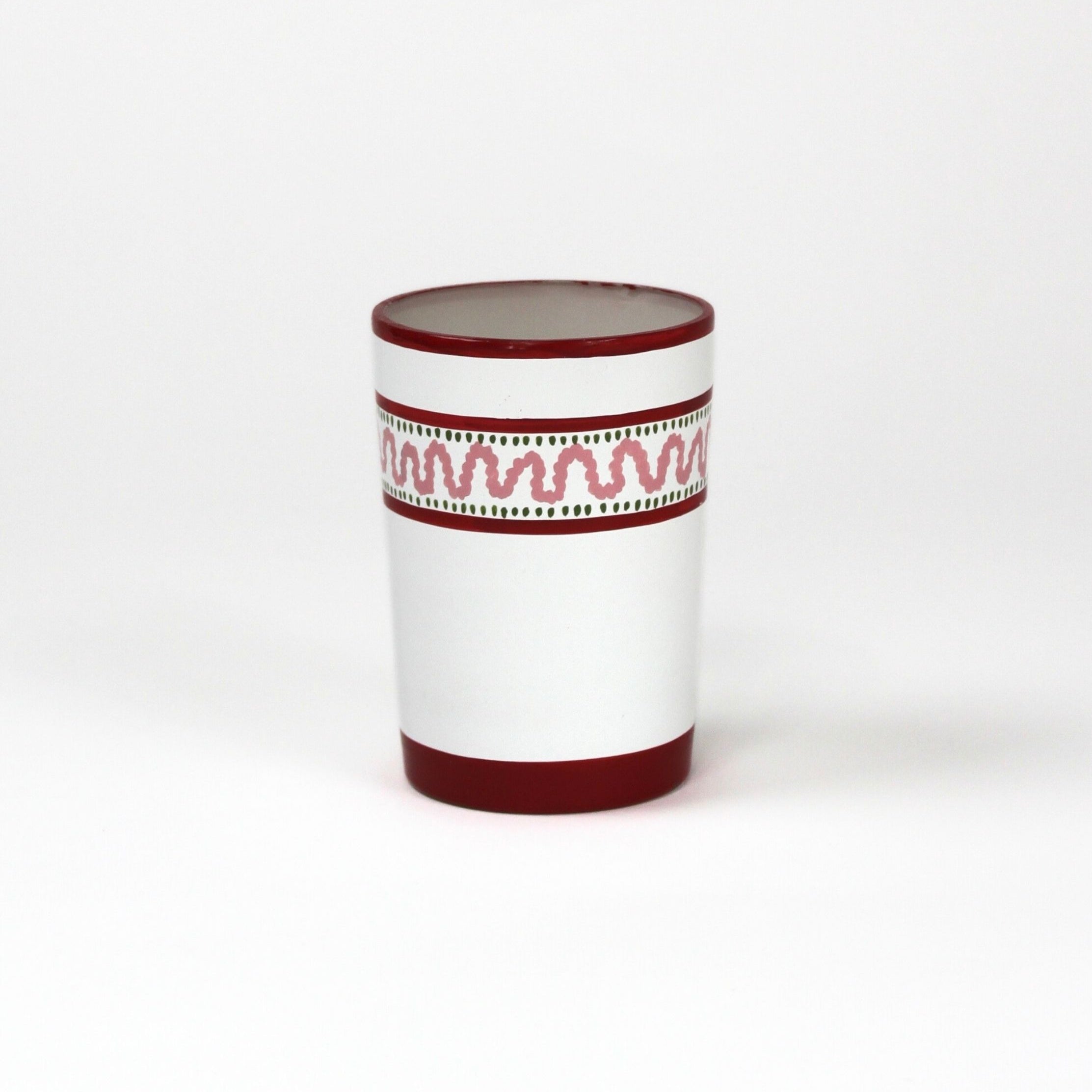 a red painted glass with a squiggly motif at the top called "Harbor Trail" by madcap cottage