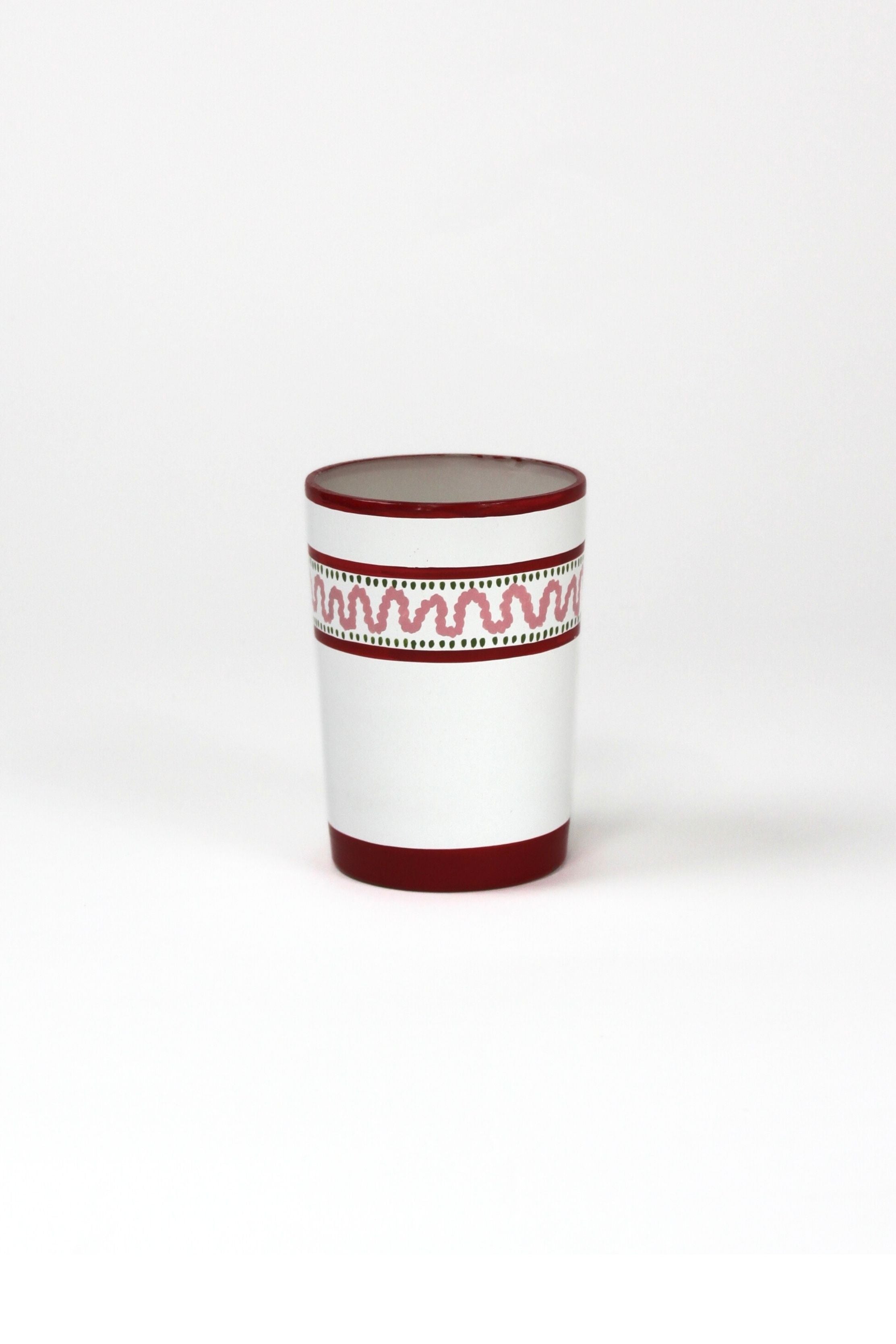a red painted glass with a squiggly motif at the top called "Harbor Trail" by madcap cottage