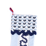 Blue Christmas stocking with blue and white striped pattern on a white background