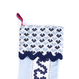 Blue Christmas stocking with blue and white striped pattern on a white background