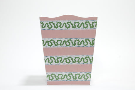 a madcap cottage pink and white striped wastepaper basket with a green squiggle down each white stripe. 