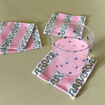 harbor trail pink and green linen cocktail coasters with blue dot drink glass