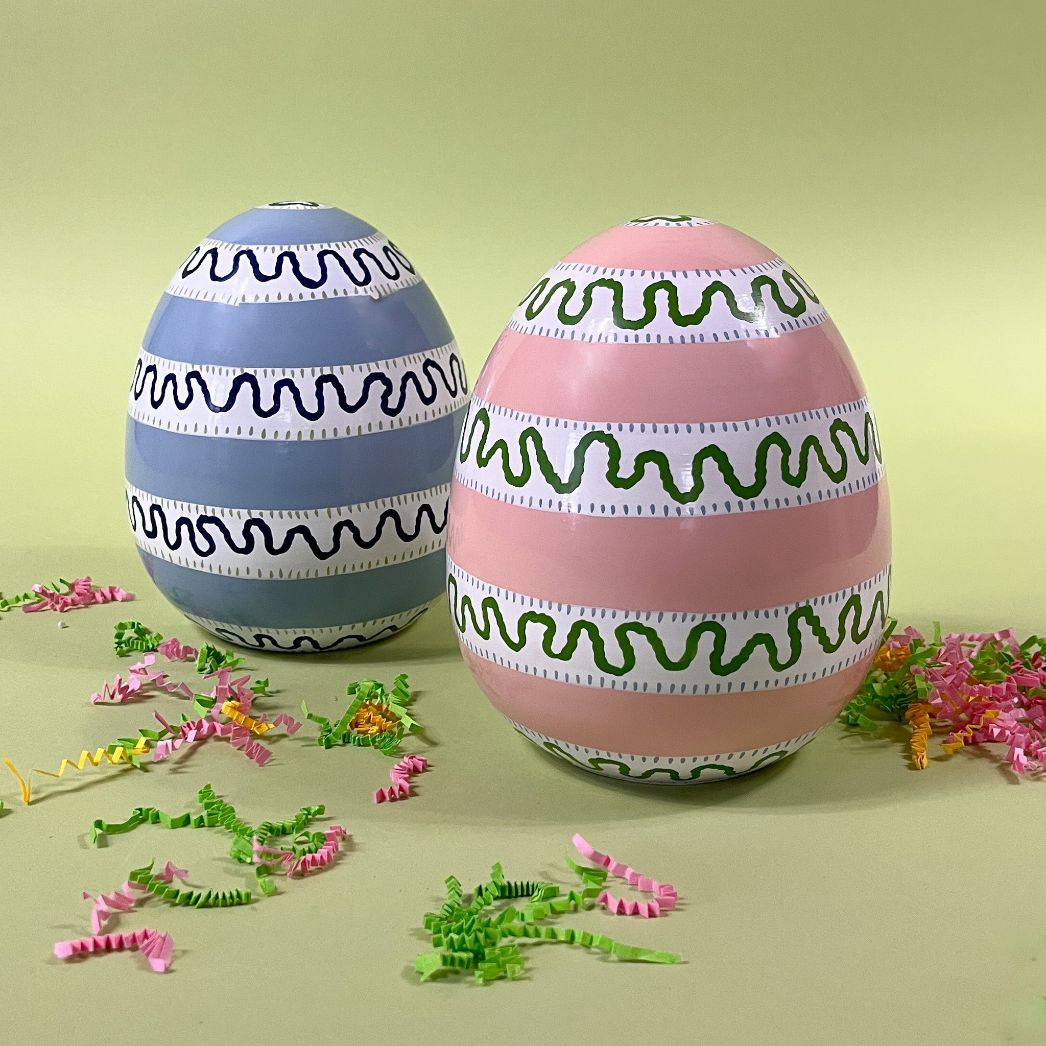 a pink and blue striped set of large decorative easter eggs