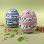a pink and blue striped set of large decorative easter eggs 