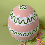a striped pink large decorative easter egg in tole metal