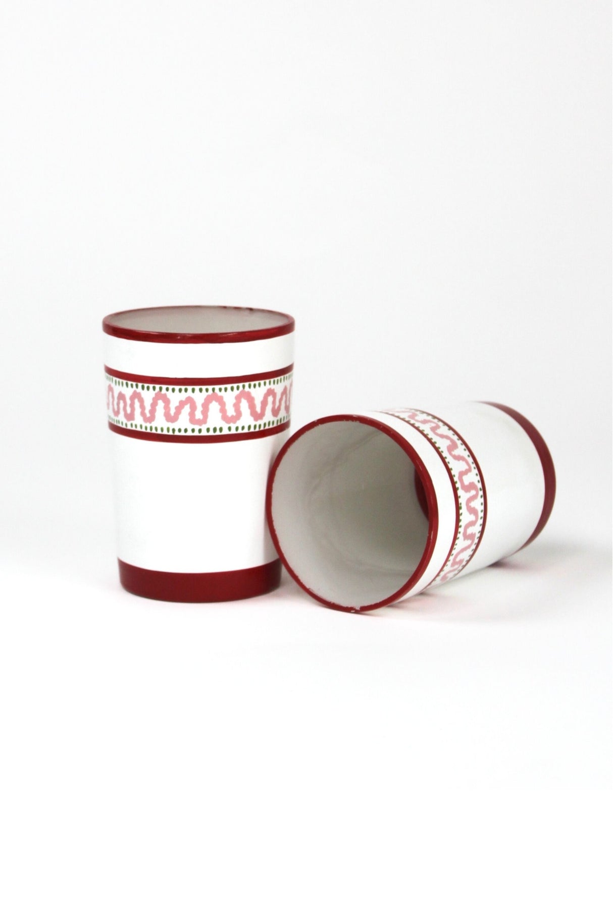 two red painted glasses with a squiggly motif at the top called "Harbor Trail" by madcap cottage