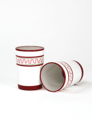 two red painted glasses with a squiggly motif at the top called "Harbor Trail" by madcap cottage