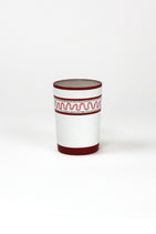 a red painted glass with a squiggly motif at the top called "Harbor Trail" by madcap cottage