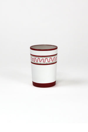 a red painted glass with a squiggly motif at the top called "Harbor Trail" by madcap cottage