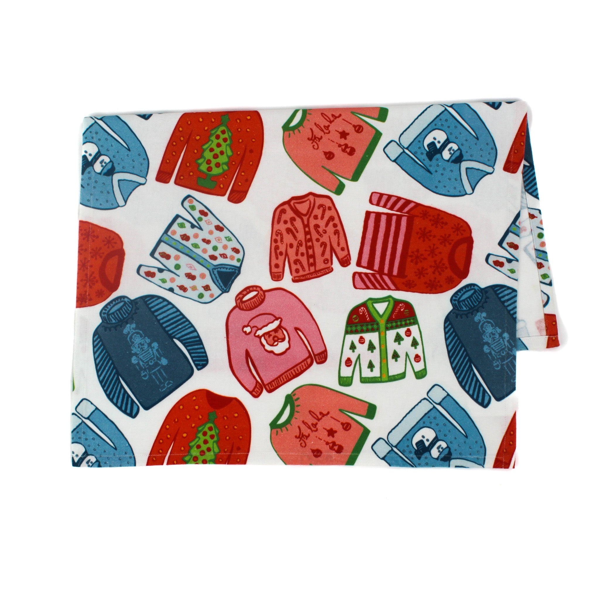 a christmas tea towel featuring a repeating holiday sweater design in red, pink and blue
