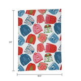 a christmas tea towel featuring a repeating holiday sweater design in red, pink and blue with dimension notation of 24" x 18.5"
