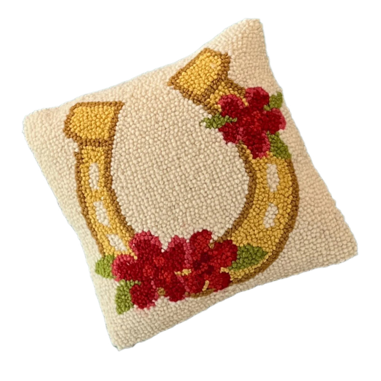 a cream pillow with a flower embellished horseshoe design 