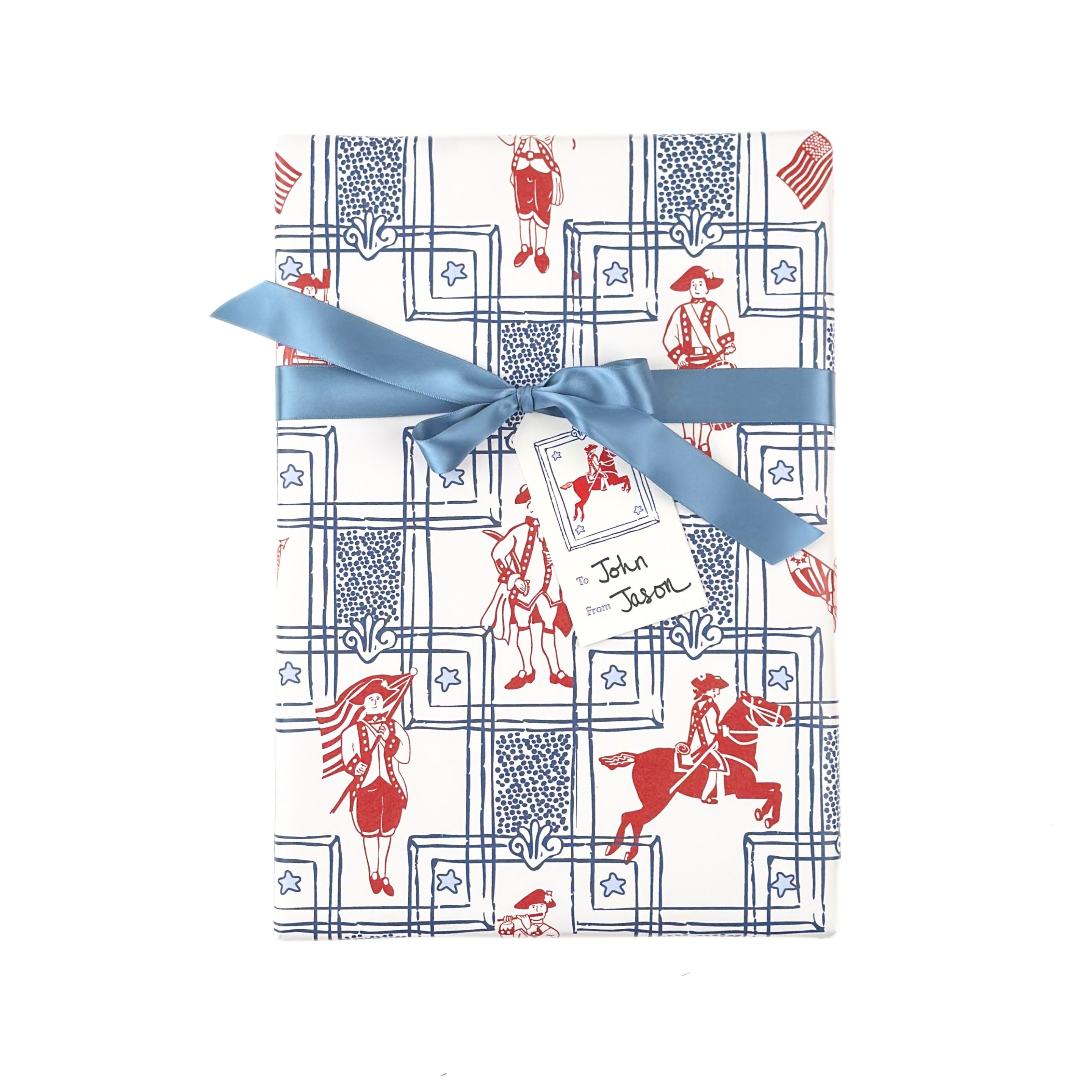 Patriotic gift wrap featuring red colonial soldiers, horseback riders, American flags, and decorative blue borders.