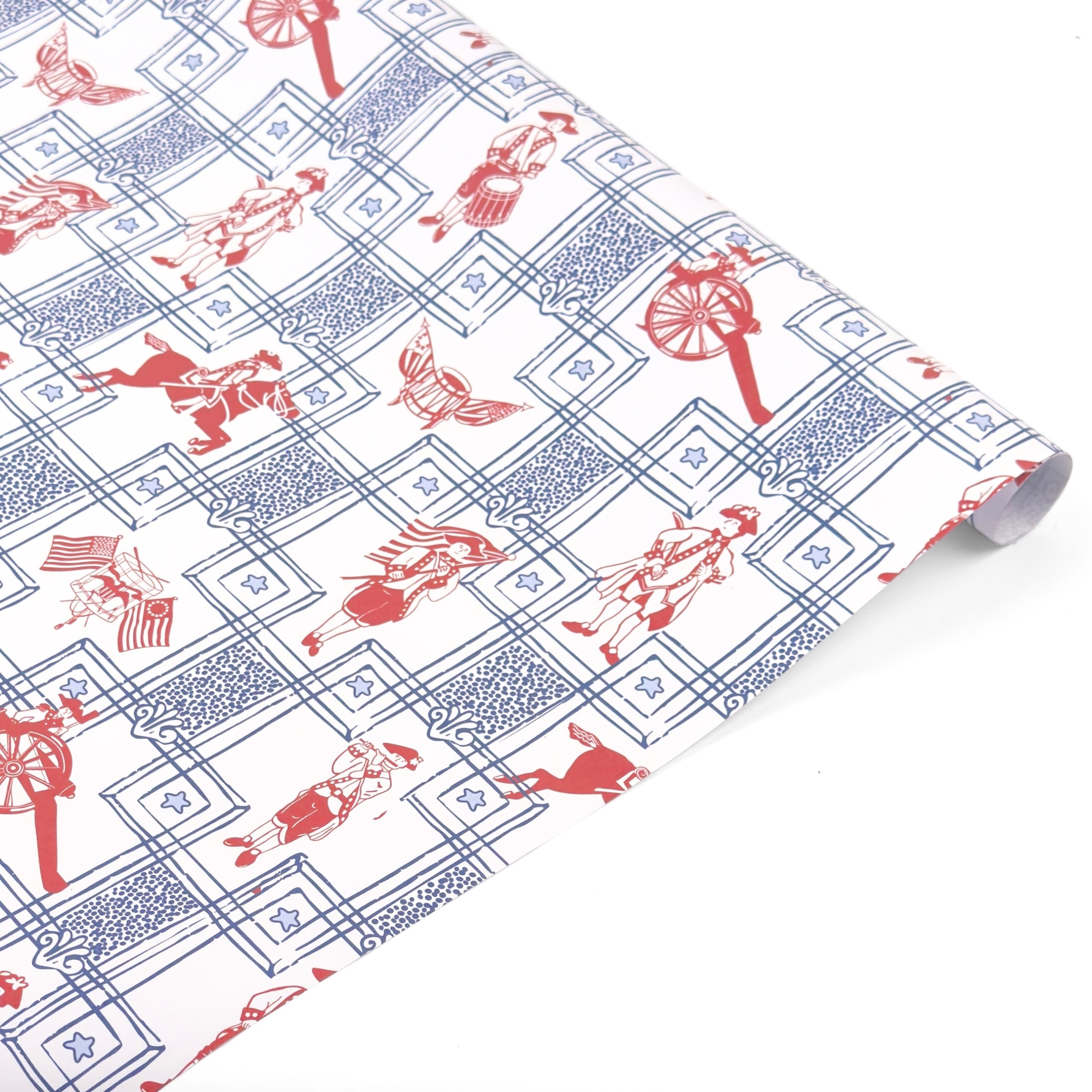 Patriotic gift wrap roll featuring red colonial soldiers, horseback riders, American flags, and blue borders.