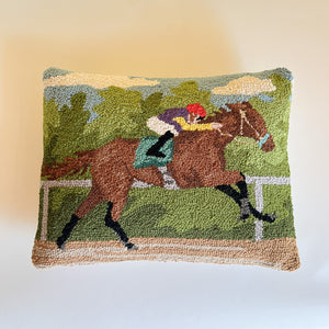 a hooked wool derby day pillow featuring a brown horse and mulitcolor jockey