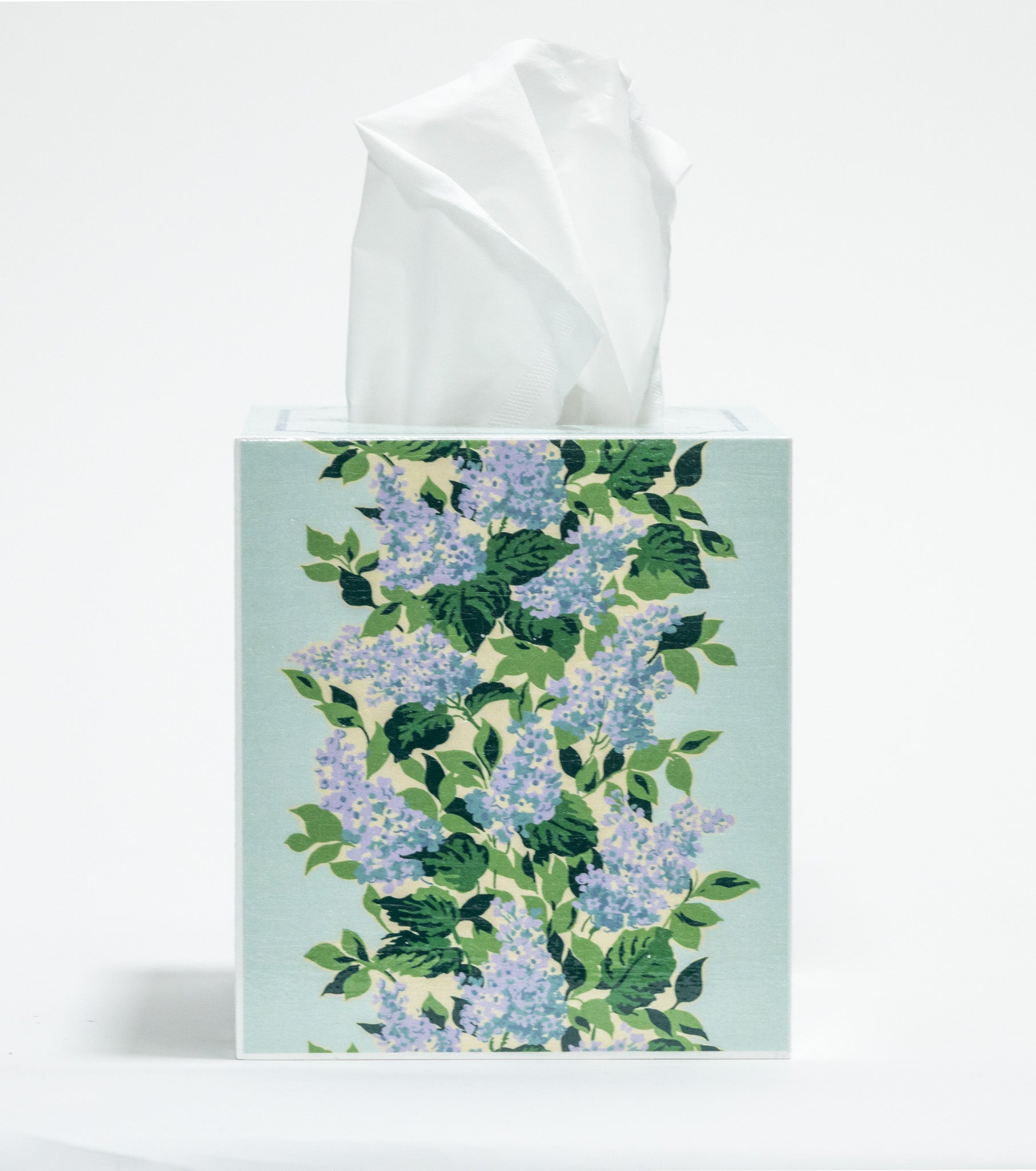a blue floral tissue box cover with a repeating hydrangea pattern down the center of each side. 