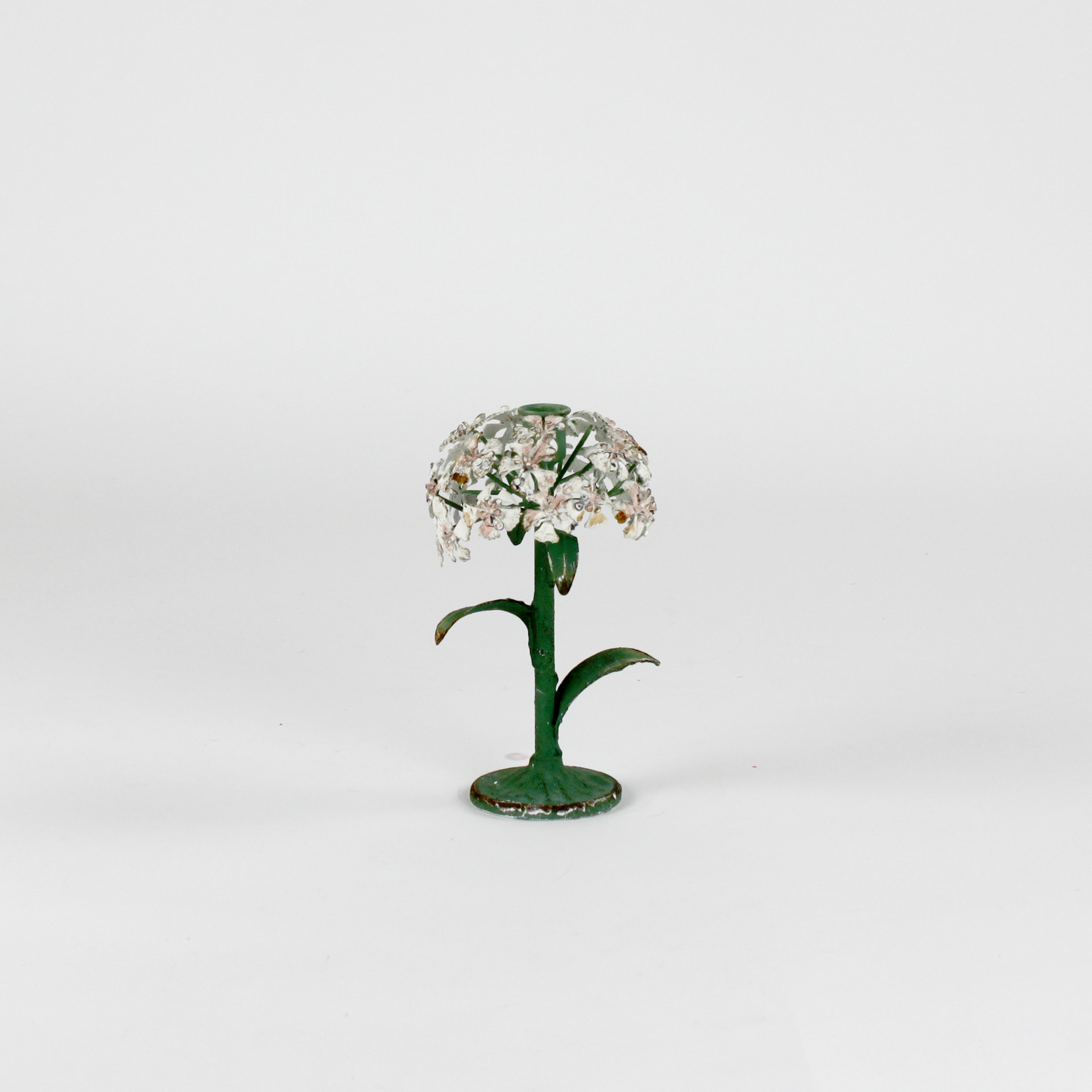 a small metal flower candle holder in the shape of a hydrangea on a white background