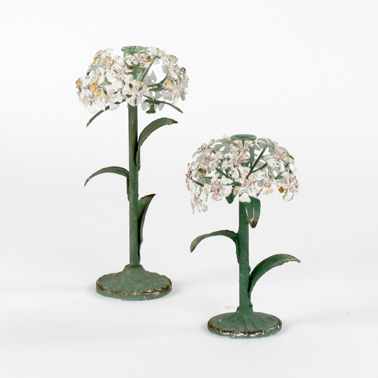 Two decorative metal hydrangea flower sculptures on a white background