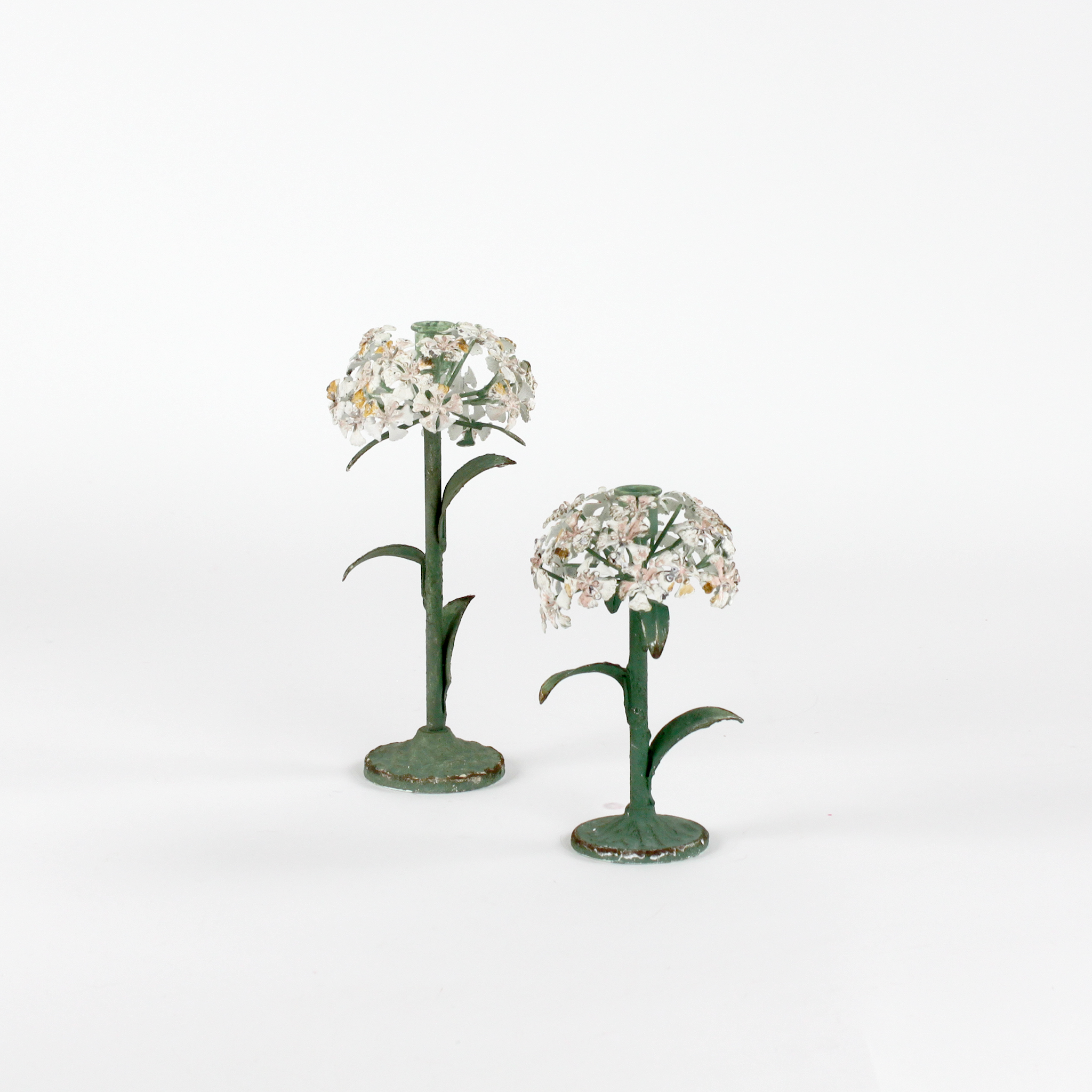 Two decorative metal hydrangea flower sculptures on a white background