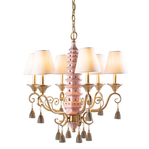 A pink pagoda chandelier with illuminated white lampshades