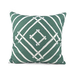 Island House outdoor pillow with green and white tropical pattern.