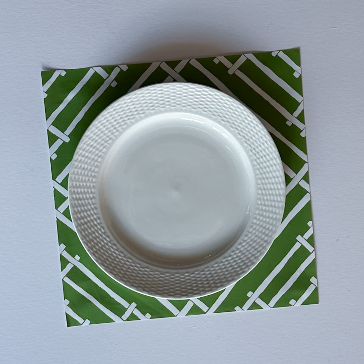 White and green paper placemats featuring a white bamboo pattern called Island House by Madcap Cottage