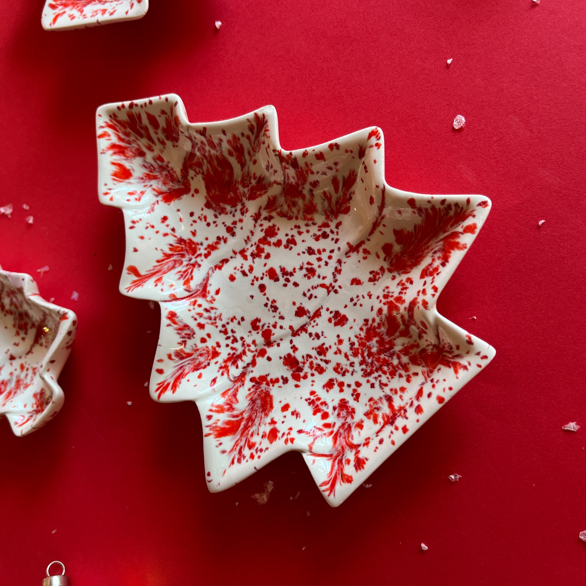 a red and white vintage christmas tree shaped plate