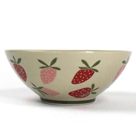 a large beige strawberry serving bowl decorated with pink and red strawberry motifs.