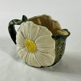 a large vintage daisy creamer with a large daisy forming the side of the pitcher. 