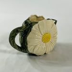a large vintage daisy creamer with a large daisy forming the side of the pitcher. 