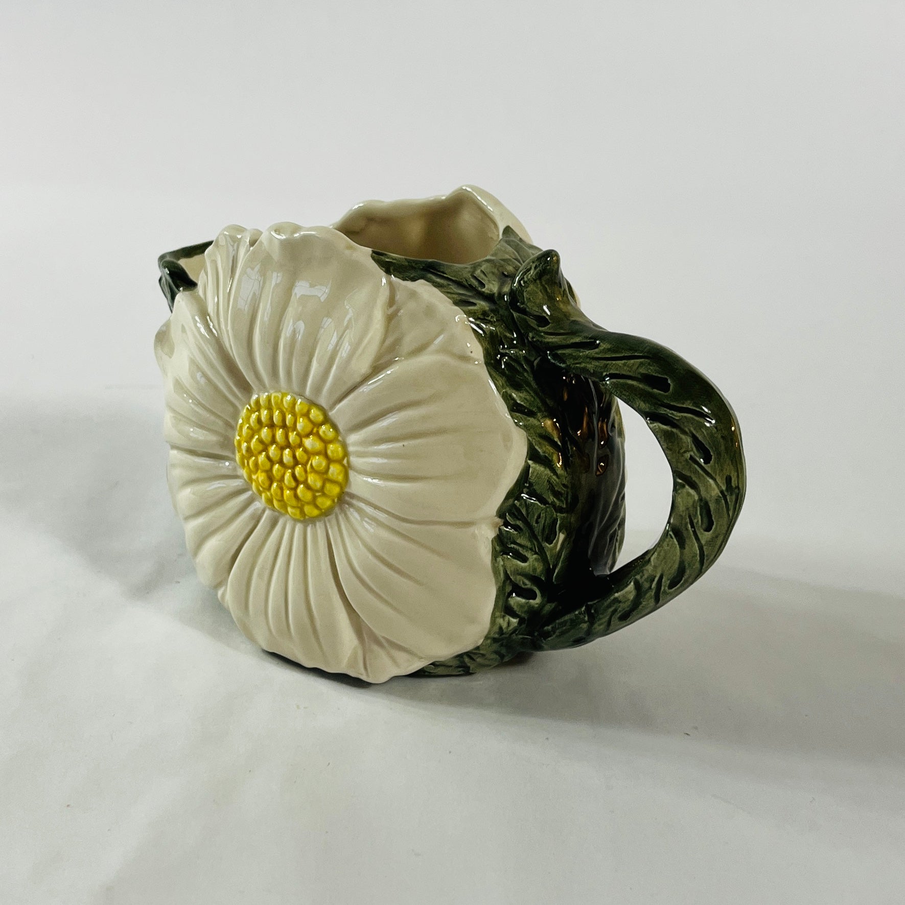 a large vintage daisy creamer with a large daisy forming the side of the pitcher. 