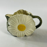 a large vintage daisy creamer with a large daisy forming the side of the pitcher. 