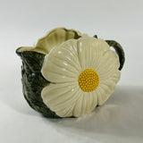 a large vintage daisy creamer with a large daisy forming the side of the pitcher. 