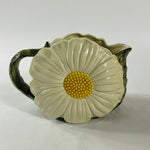 a large vintage daisy creamer with a large daisy forming the side of the pitcher. 